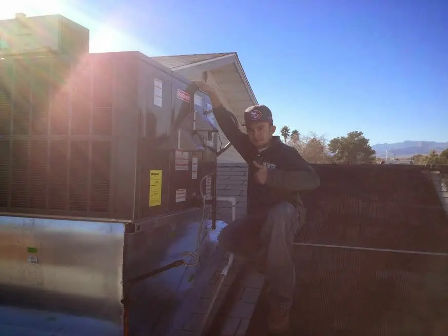 HVAC technician performing Heat Pump Repair on a rooftop unit in Mount Lebanon